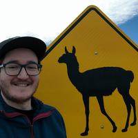 Selfie of me infront of a alpaca warning sign.