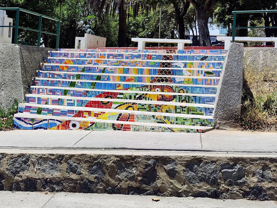 Stone steps to a public park done in coloured tile mosaic.