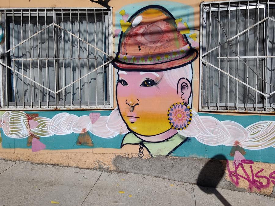 Street art of a woman with long white hair.