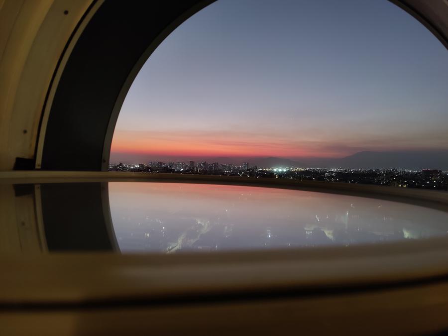 A view of my the sunset reflected by the circular window.