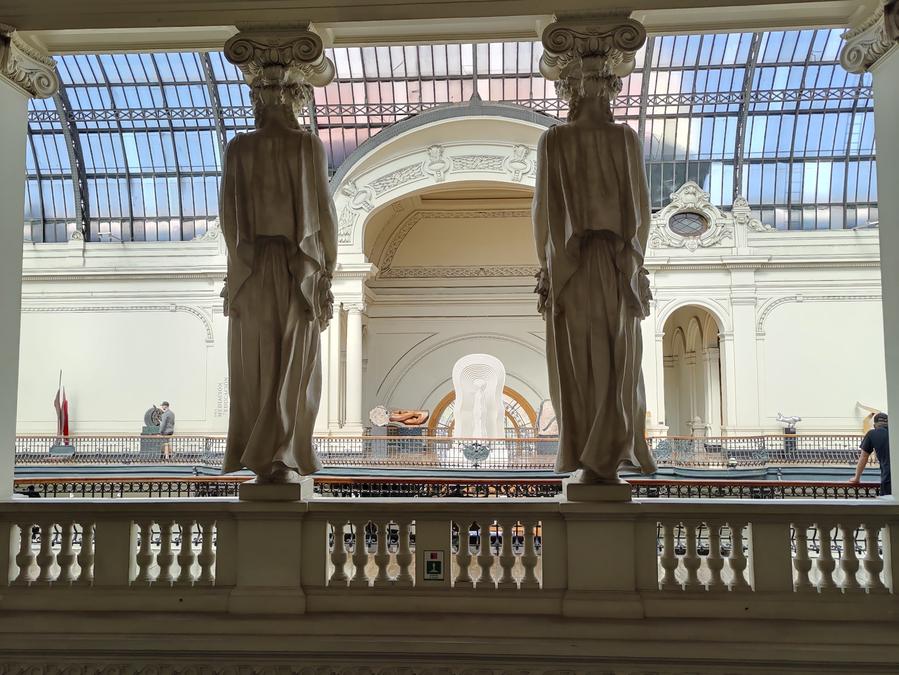 Twin female sculpture pillars as seen from behind.