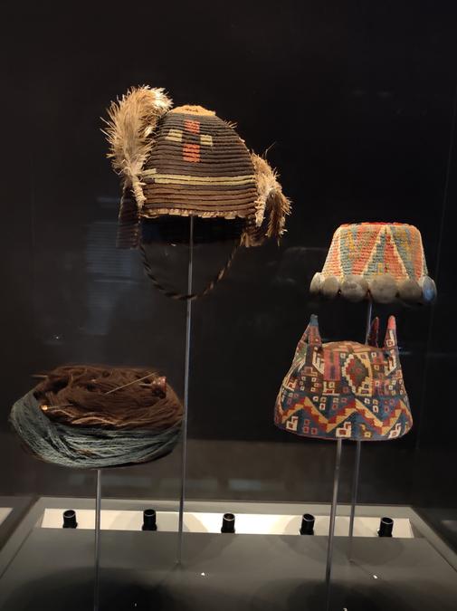 Four hats on display from various pre-Columbian cultures.