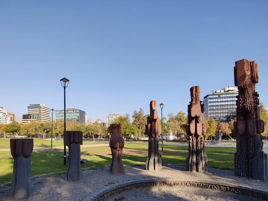 A sculpture consisting of six pillars with undulating texture.