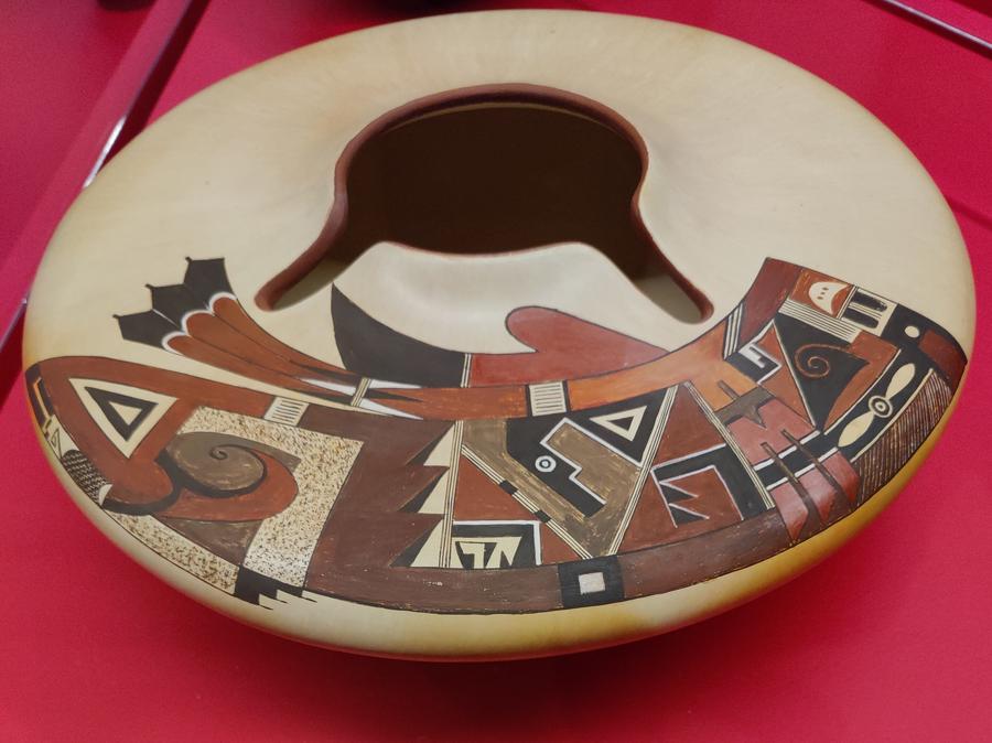 A beautiful bowl displayed at MBAM with an indigenous image painted on it.